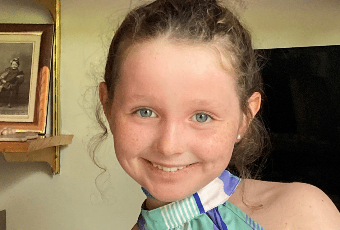A picture of a girl, ruth, who is smiling at the camera