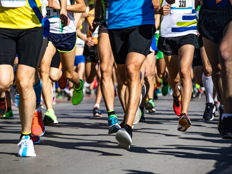A picture of marathon runners running on a road.