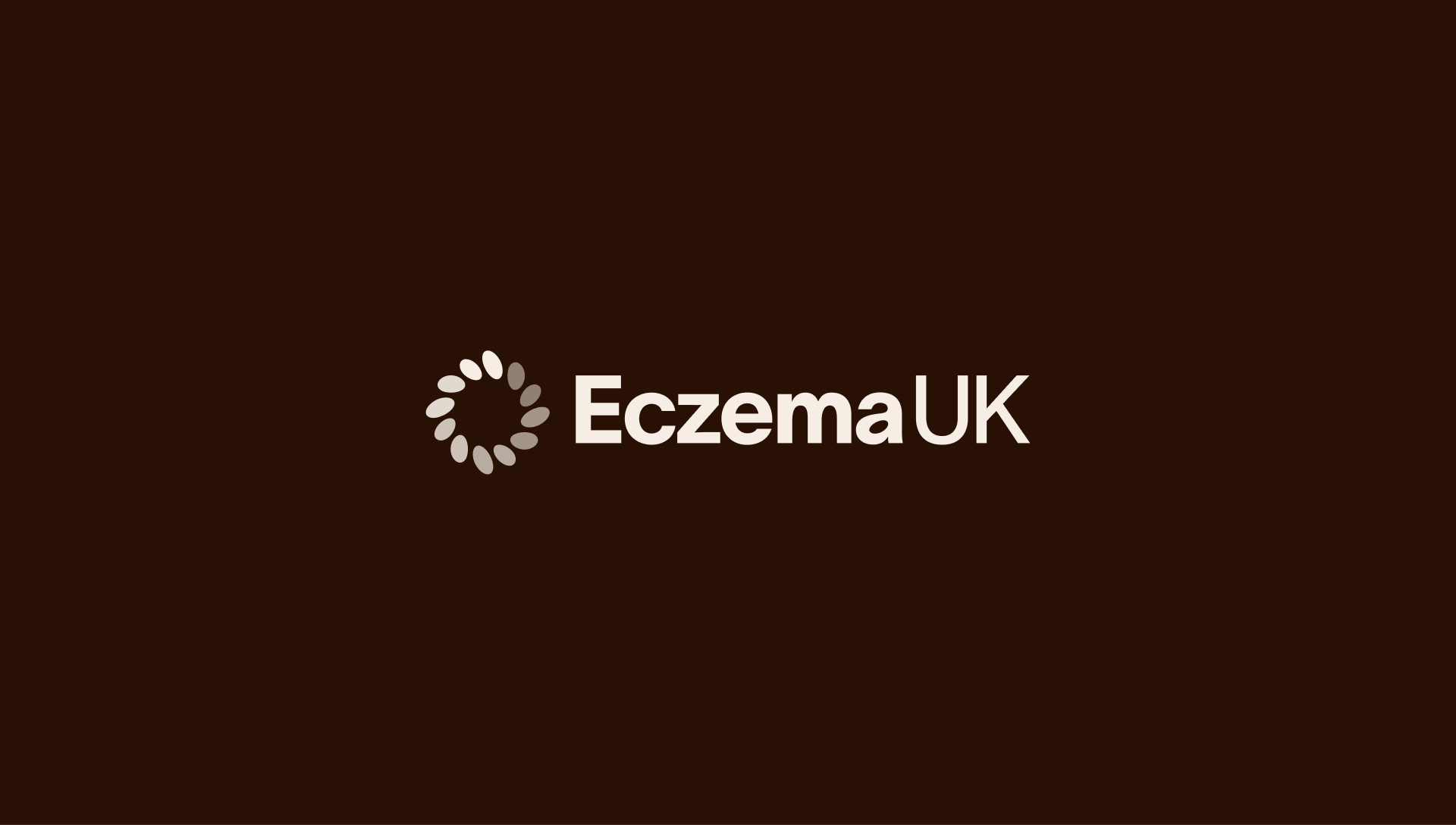 Eczema UK new logo shown in ivory on an ebony background.
